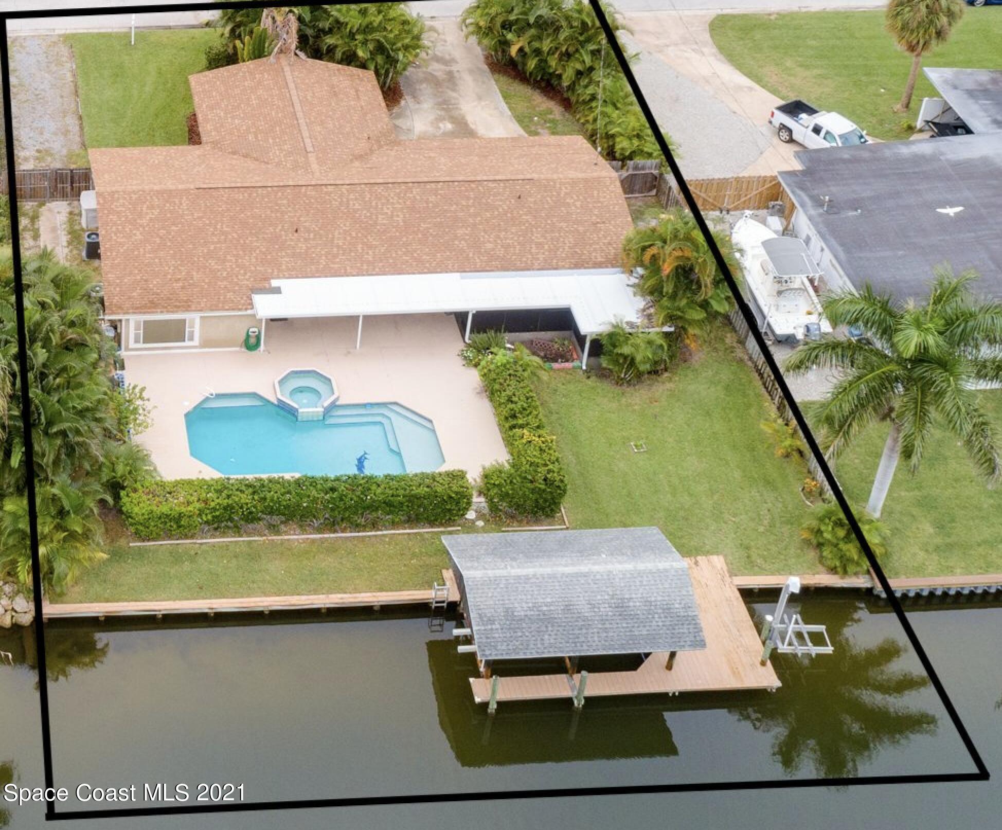 931 Bali Road Cocoa Beach, FL 32931 - Photo 1 of 42 an aerial view of a house with a yard