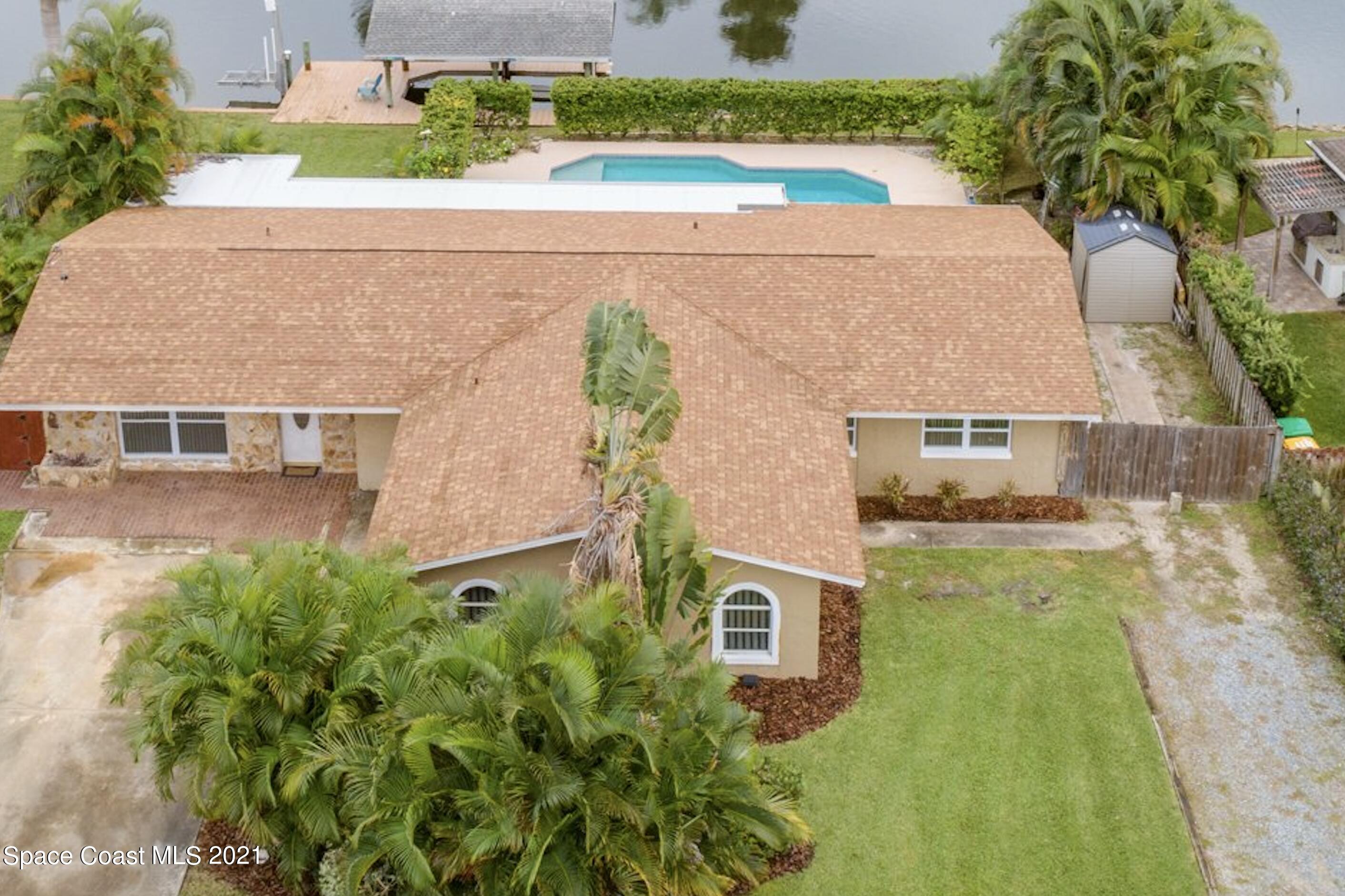 931 Bali Road Cocoa Beach, FL 32931 - Photo 3 of 42 an aerial view of a house with a yard basket ball court and outdoor seating
