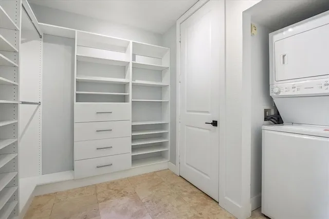 a view of walk in closet with empty racks