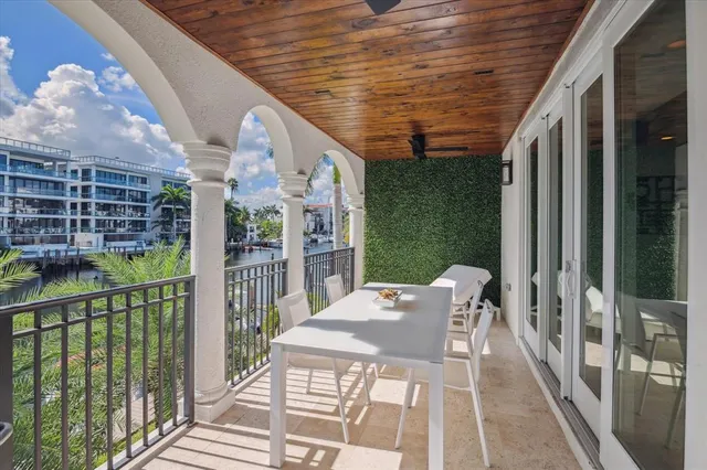 a bedroom with a bed a mirror on the wall and a flat screen tv