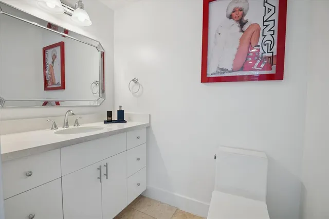 a bathroom with a sink toilet vanity and bathtub
