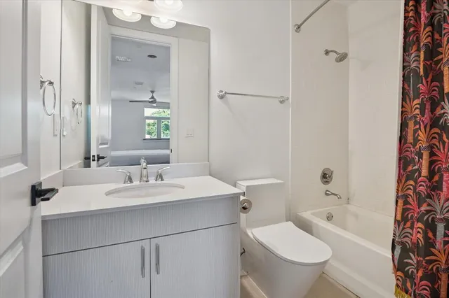 a bathroom with a sink a toilet and shower curtain