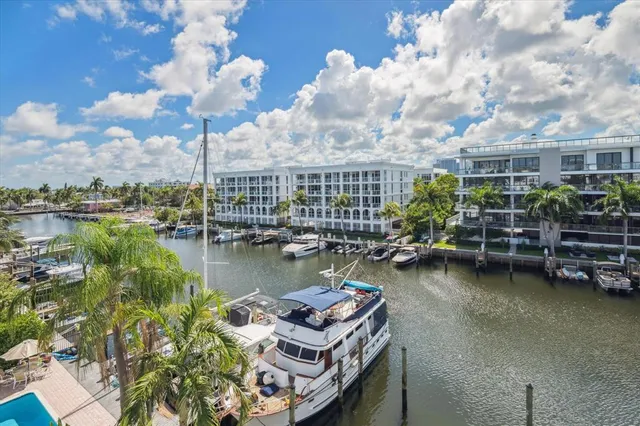 a view of a brick house with a yard chairs and a table