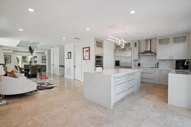 a large white kitchen with cabinets