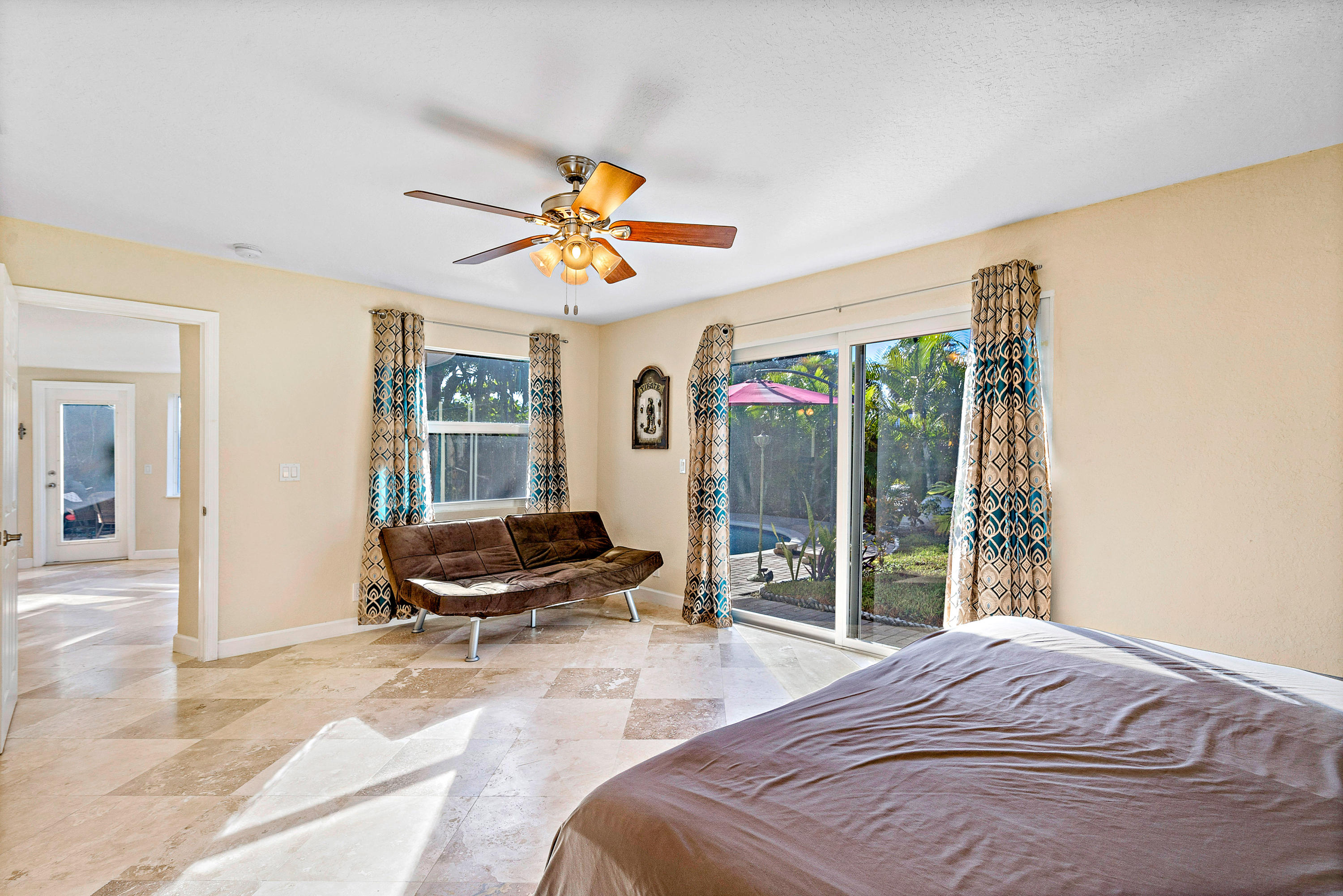 208 Bamboo Road Palm Beach Shores, FL 33404 - Photo 19 of 30 a bedroom with a bed and glass window
