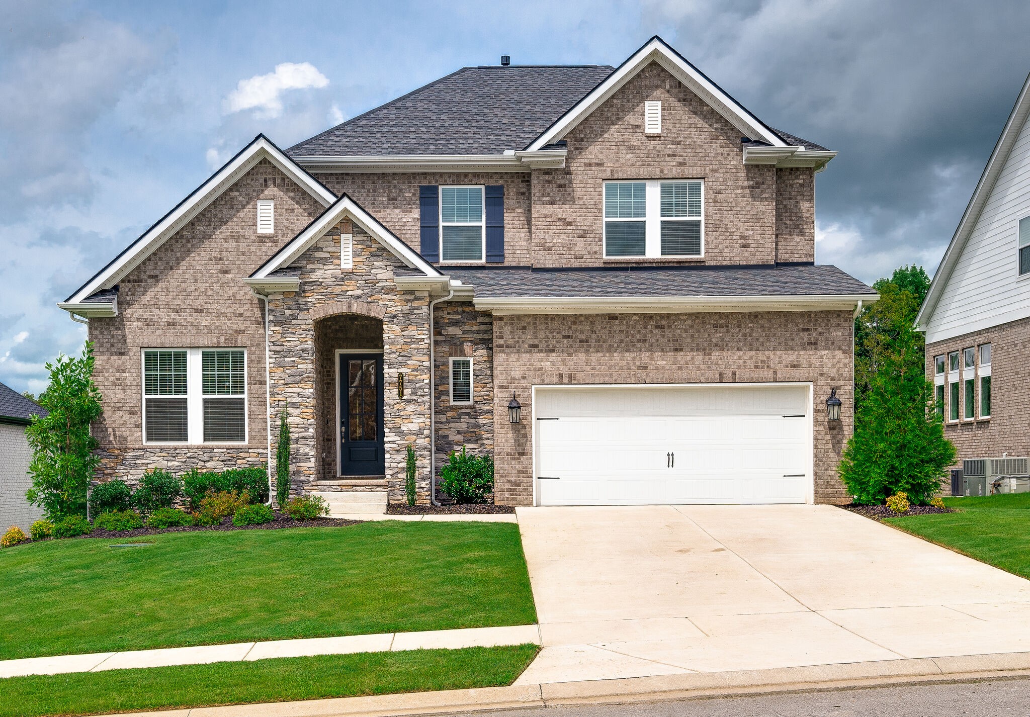 7751 Thayer Road Nolensville, TN 37135 - Photo 5 of 69 a front view of a house with a yard and garage