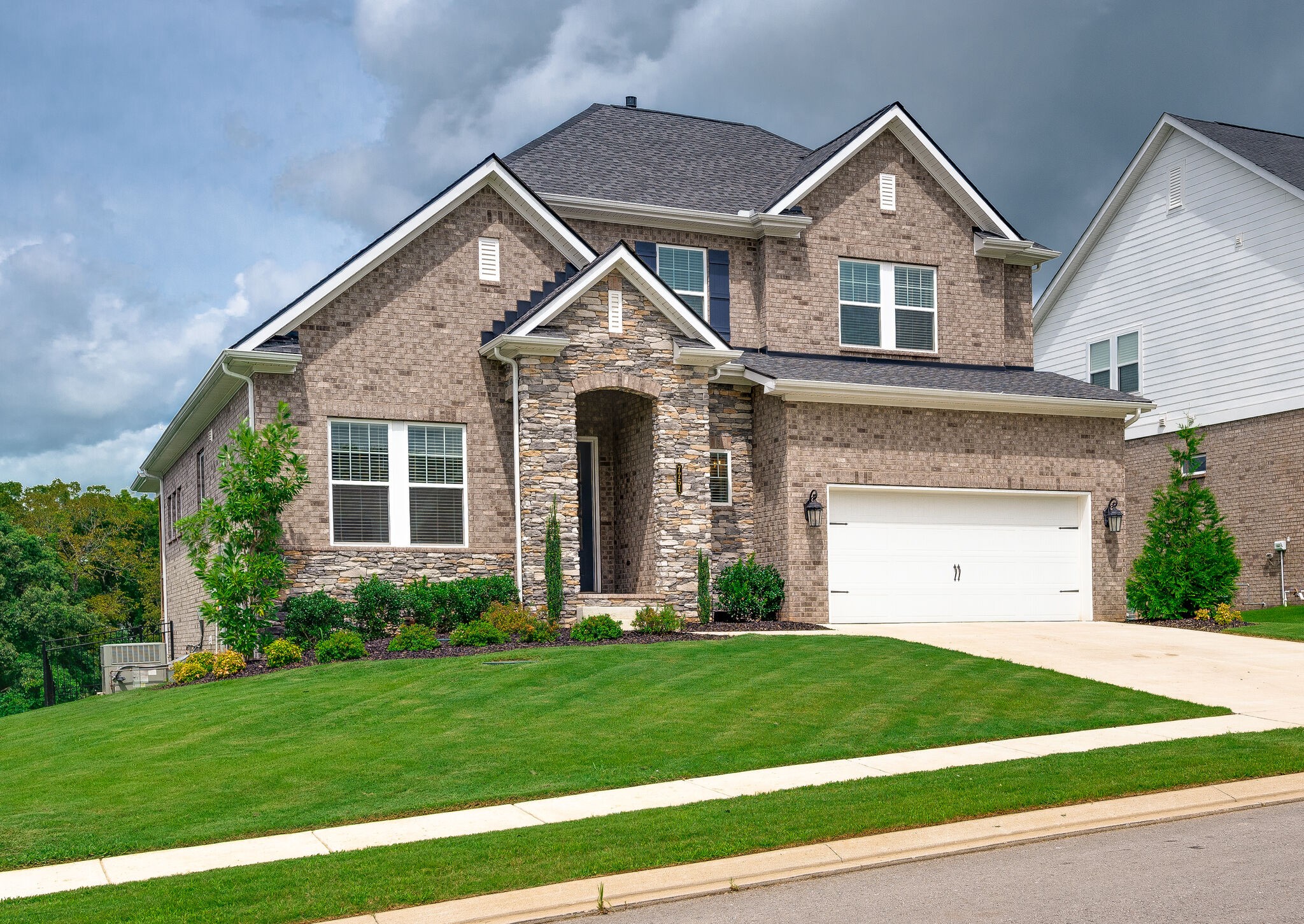 7751 Thayer Road Nolensville, TN 37135 - Photo 6 of 69 a front view of a house with a garden and plants