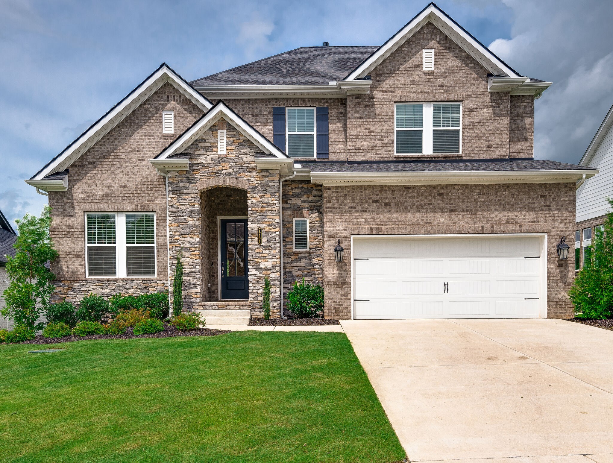 7751 Thayer Road Nolensville, TN 37135 - Photo 8 of 69 a front view of a house with a yard and garage