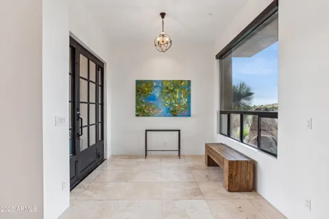 a large kitchen with stainless steel appliances a large counter top a stove a chimney a sink and a large window