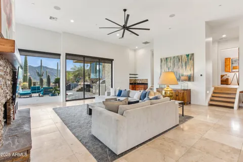 a kitchen with a dining table chairs and living room view
