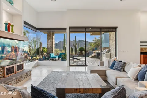 a living room with a bed furniture and a large window