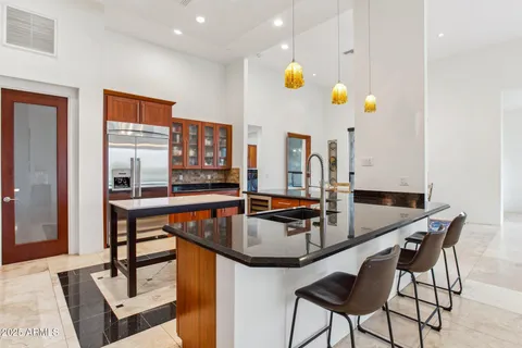 a bath tub sitting next to a blue sink and vanity