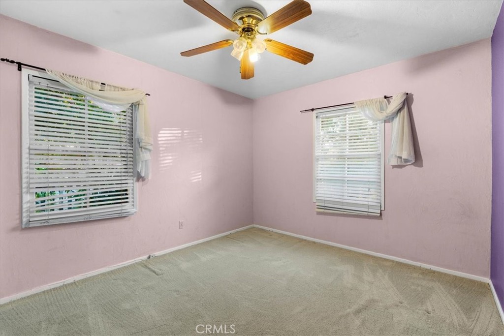 2807 Wyoming Way Riverside, CA 92506 - Photo 24 of 40 an empty room with windows and fan
