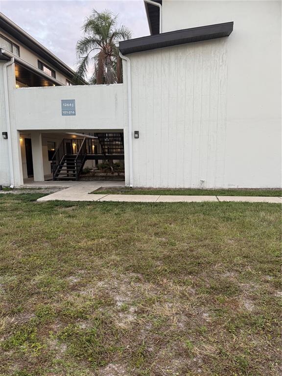 1264 East 113th Avenue, Unit J102 Tampa, FL 33612 - Photo 1 of 9 a view of a livingroom with an empty space and a fireplace