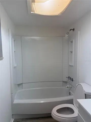 a bathroom with a toilet and bathtub