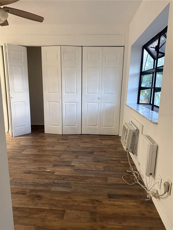 1264 East 113th Avenue, Unit J102 Tampa, FL 33612 - Photo 7 of 9 a view of an empty room with wooden floor and window