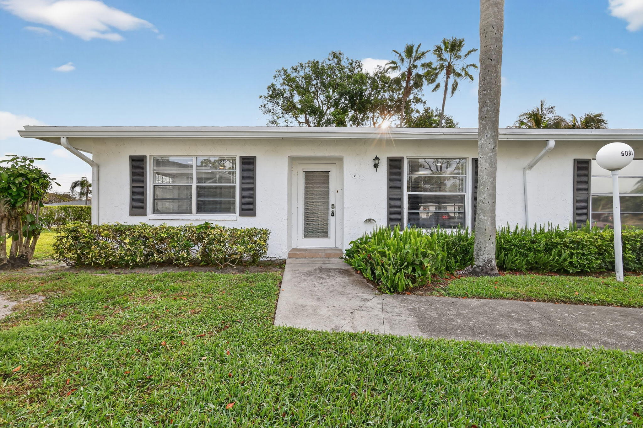 5093 Privet Place, Unit A1 Delray Beach, FL 33484 - Photo 1 of 54 front view of a house with a yard