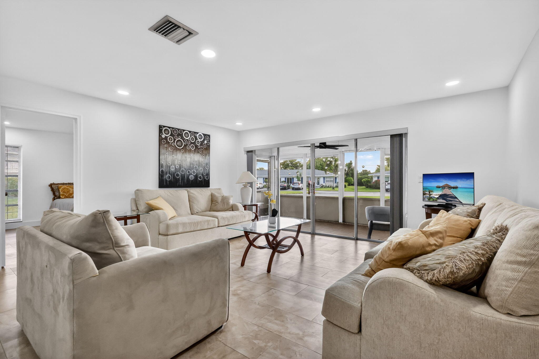 5093 Privet Place, Unit A1 Delray Beach, FL 33484 - Photo 16 of 54 a living room with furniture and a large window