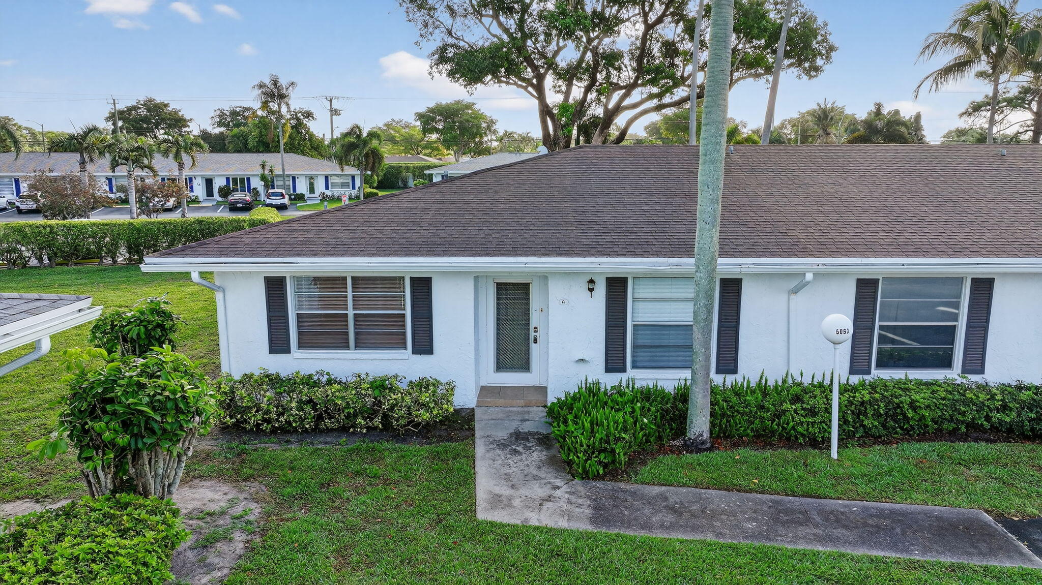 5093 Privet Place, Unit A1 Delray Beach, FL 33484 - Photo 2 of 54 a view of a house with garden and plants
