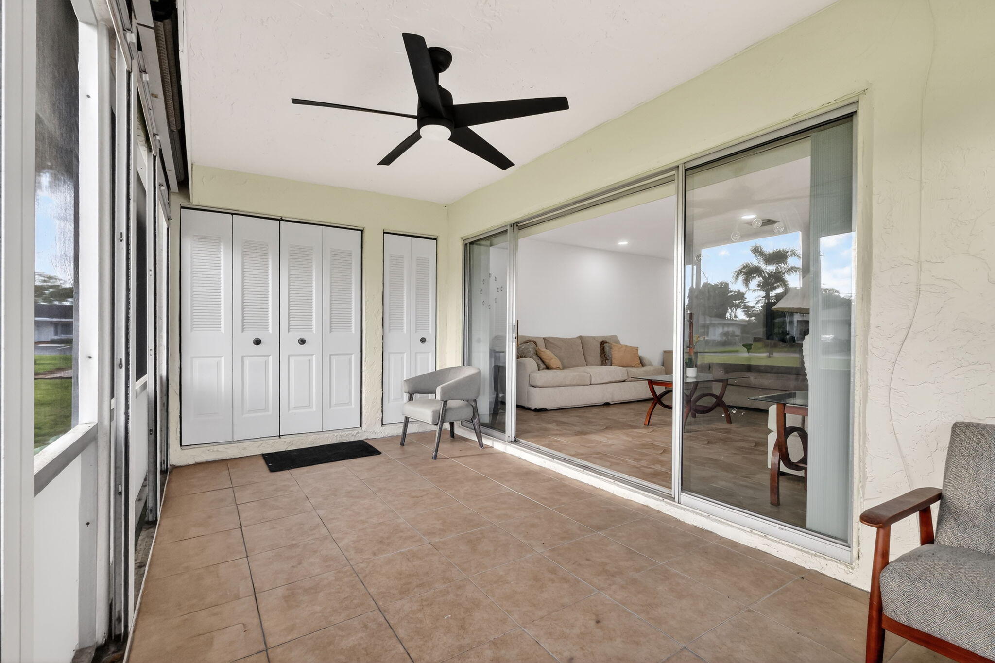 5093 Privet Place, Unit A1 Delray Beach, FL 33484 - Photo 22 of 54 a living room with furniture and a large window