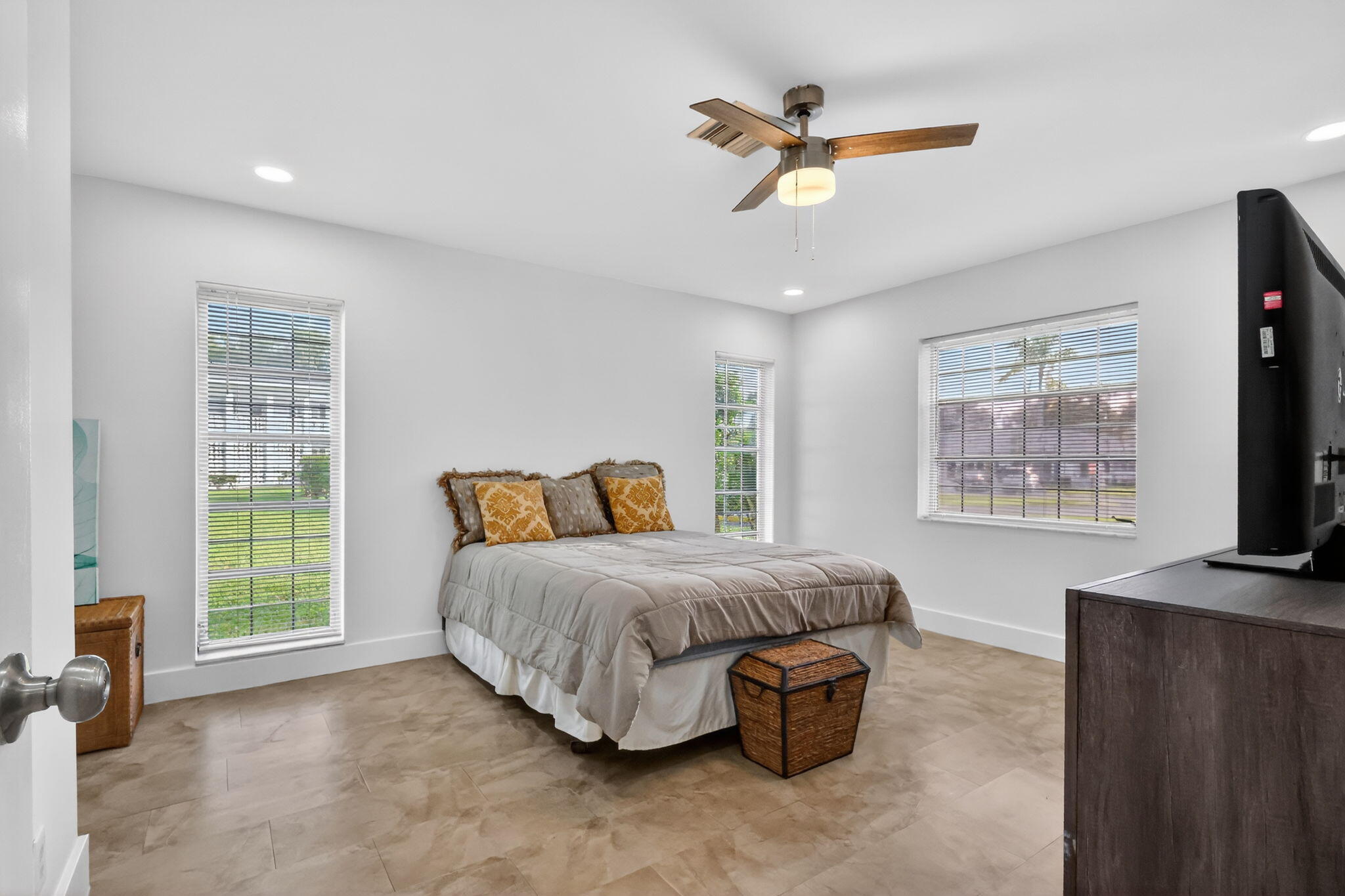 5093 Privet Place, Unit A1 Delray Beach, FL 33484 - Photo 25 of 54 a living room with a bed furniture and a flat screen tv