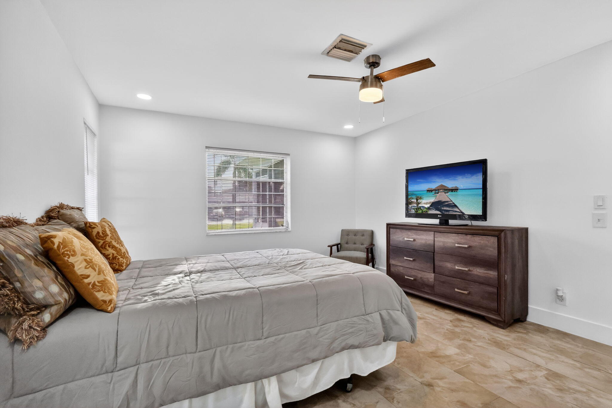 5093 Privet Place, Unit A1 Delray Beach, FL 33484 - Photo 26 of 54 a bedroom with a bed and a dresser