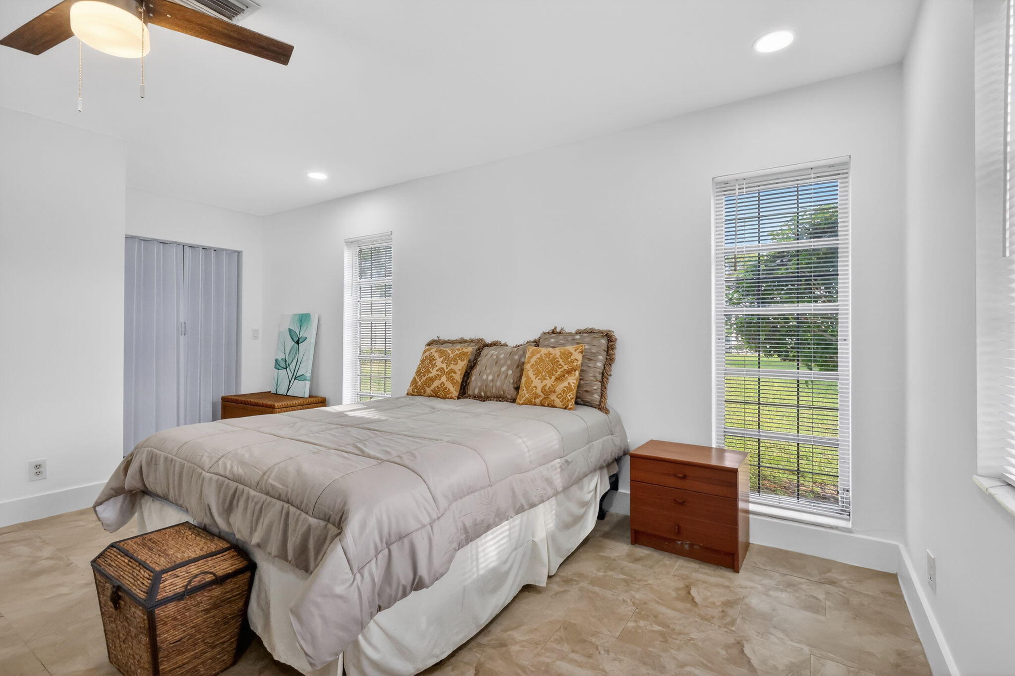 5093 Privet Place, Unit A1 Delray Beach, FL 33484 - Photo 27 of 54 a bedroom with a bed and a window