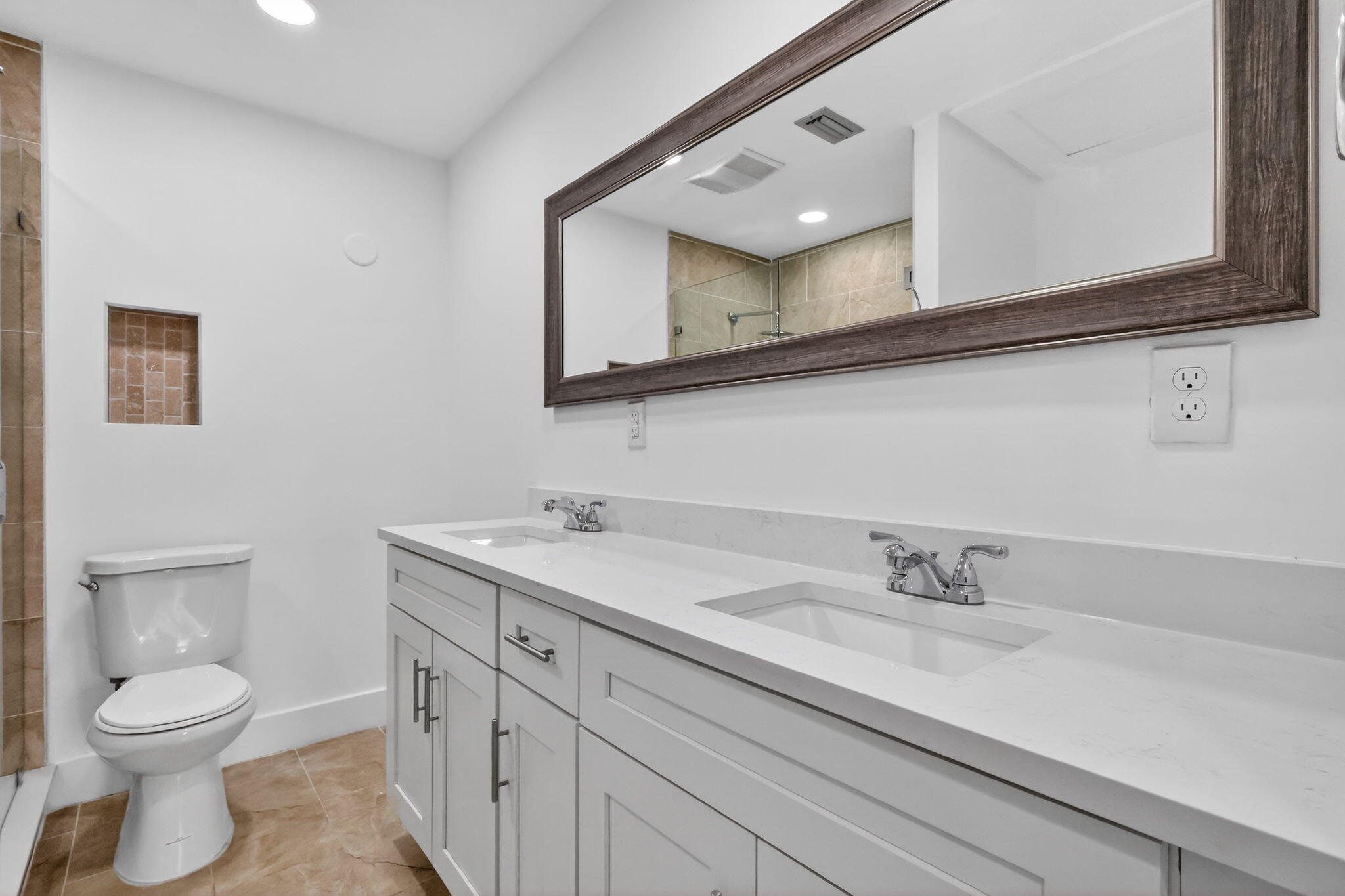 5093 Privet Place, Unit A1 Delray Beach, FL 33484 - Photo 28 of 54 a bathroom with a toilet a sink and mirror