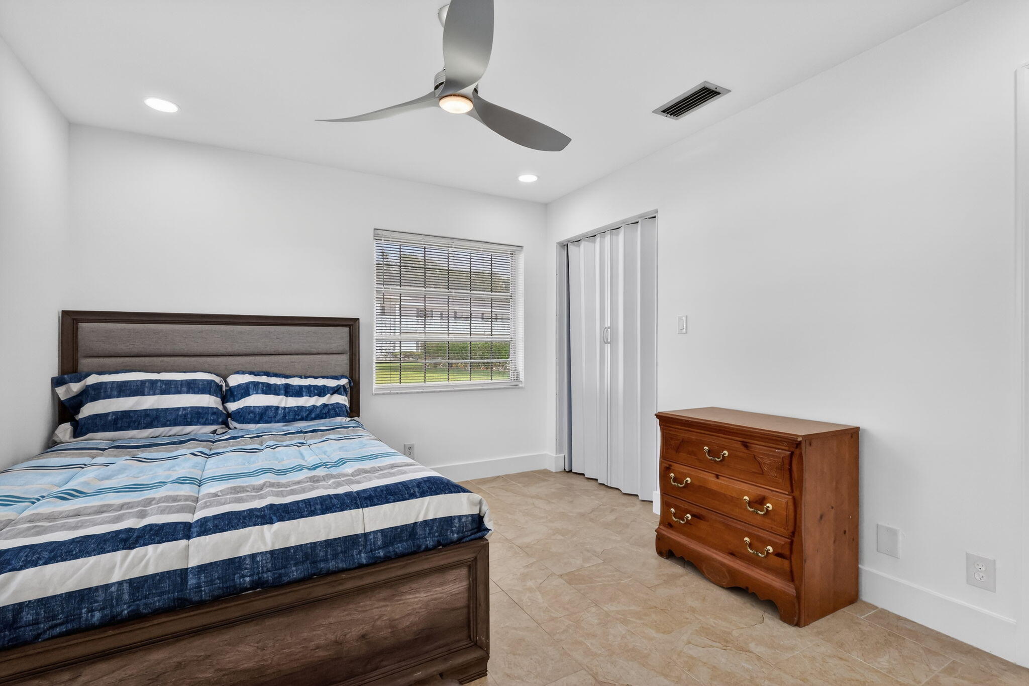 5093 Privet Place, Unit A1 Delray Beach, FL 33484 - Photo 32 of 54 a bedroom with a bed and a window