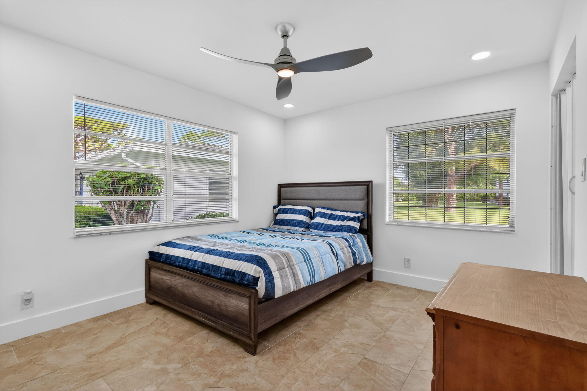 5093 Privet Place, Unit A1 Delray Beach, FL 33484 - Photo 33 of 54 a bed sitting in a bedroom next to a window