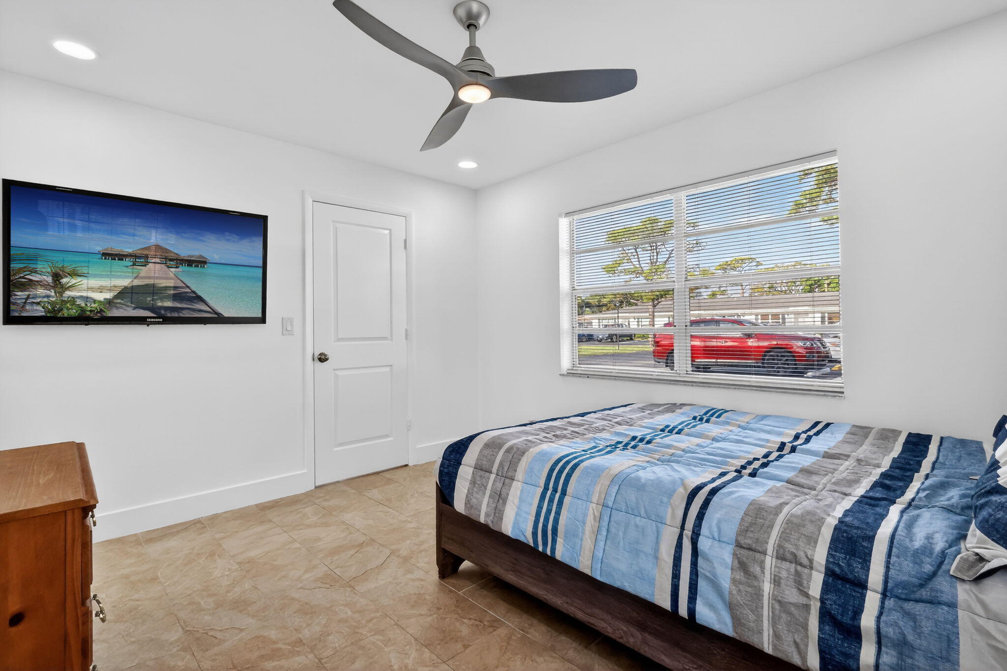 5093 Privet Place, Unit A1 Delray Beach, FL 33484 - Photo 34 of 54 a bedroom with bed and wall painting