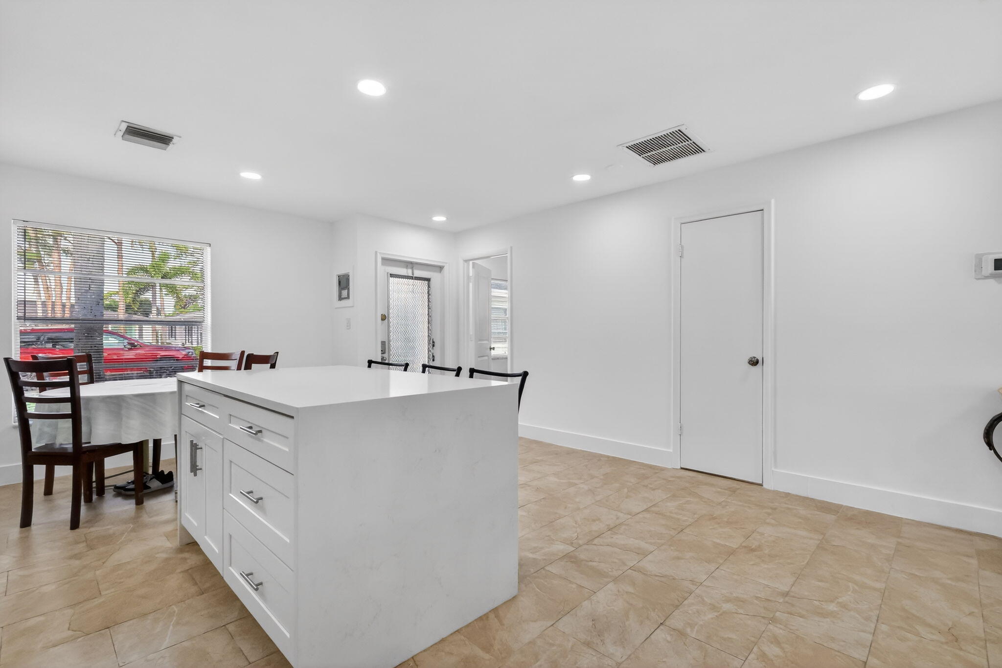 5093 Privet Place, Unit A1 Delray Beach, FL 33484 - Photo 7 of 54 a large white kitchen with a white countertops and cabinets
