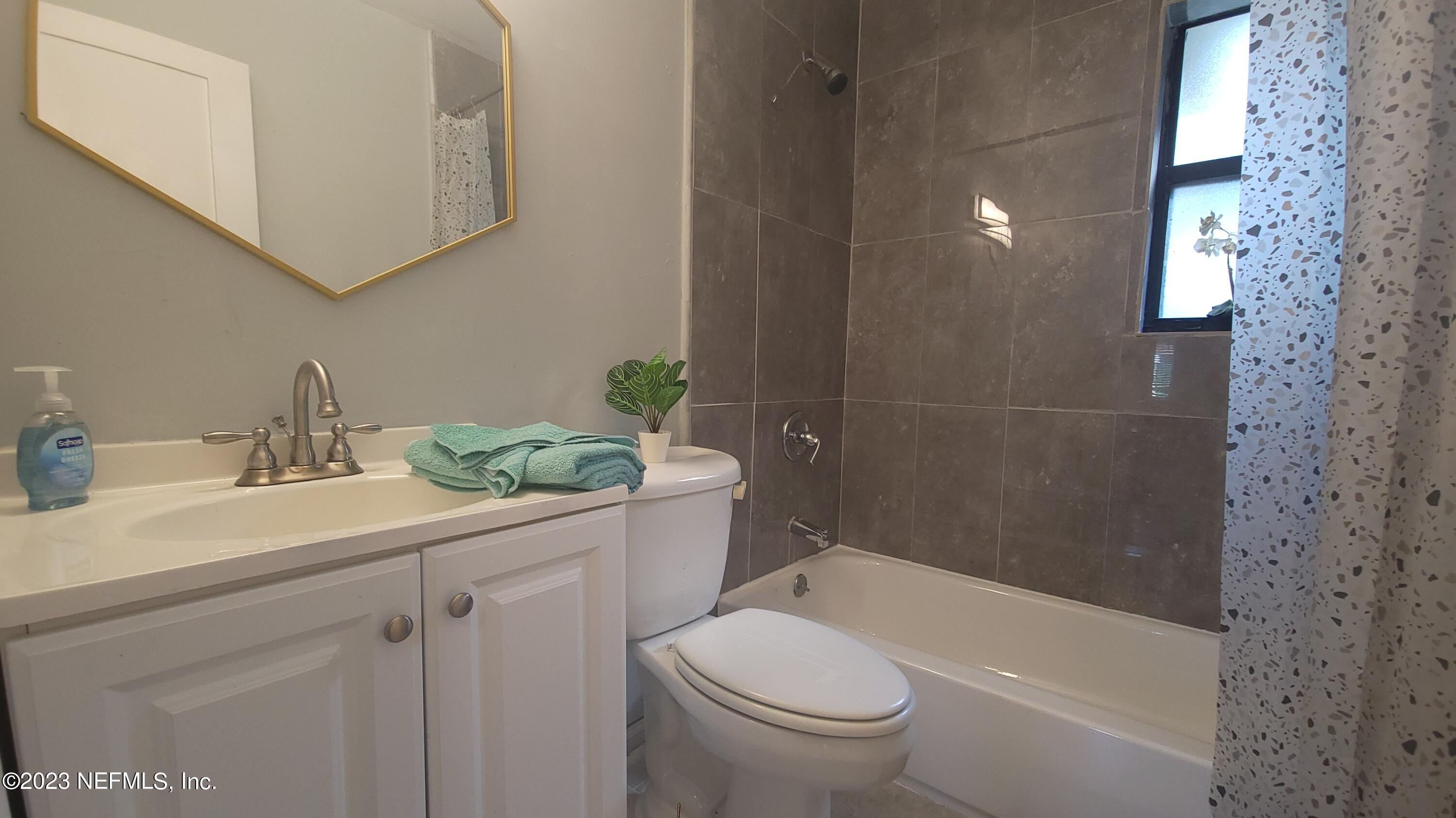 5721 Bree Road Jacksonville, FL 32209 - Photo 13 of 15 a bathroom with a sink a toilet and shower