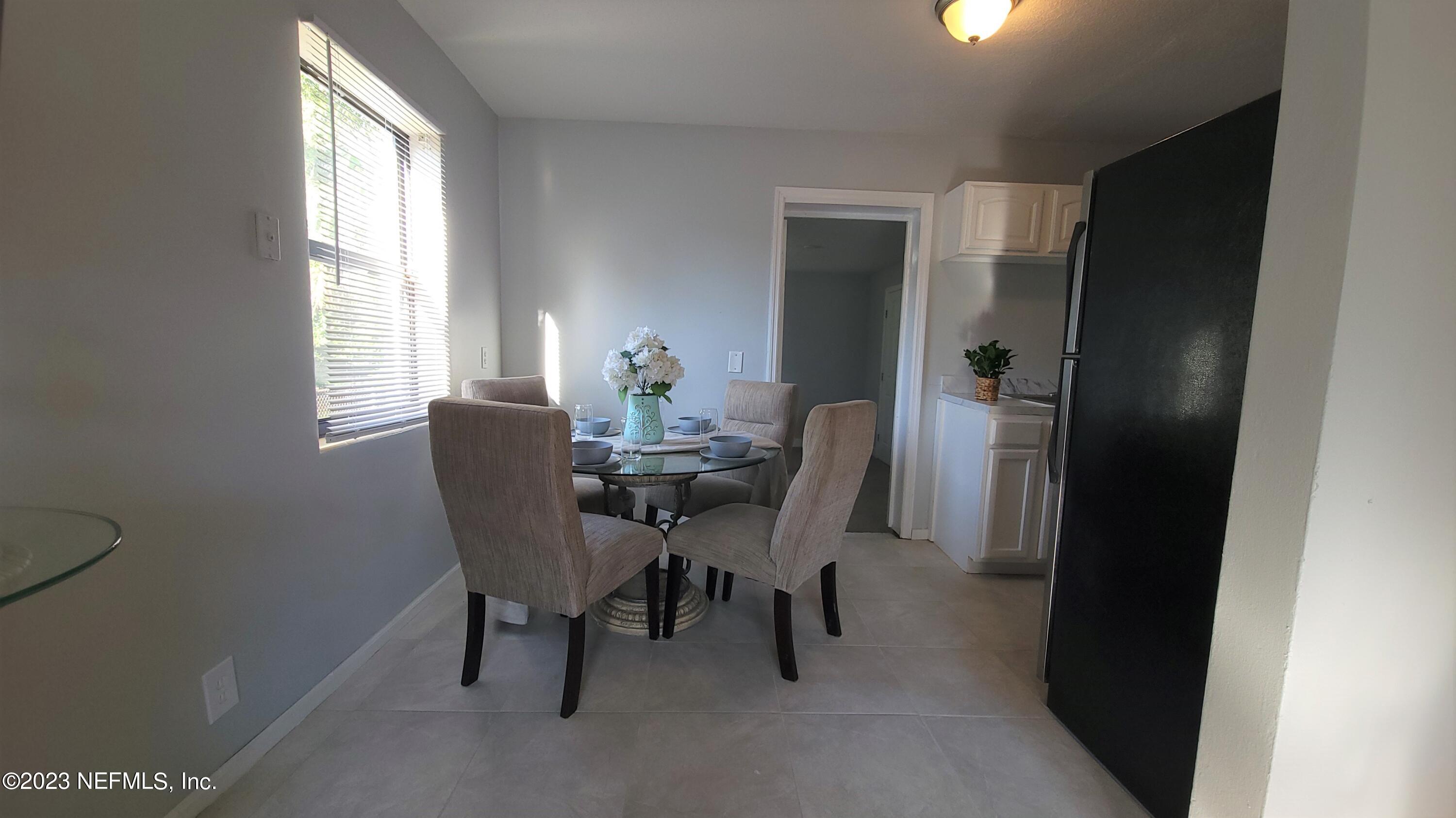 5721 Bree Road Jacksonville, FL 32209 - Photo 4 of 15 a view of a dining room with furniture and a window