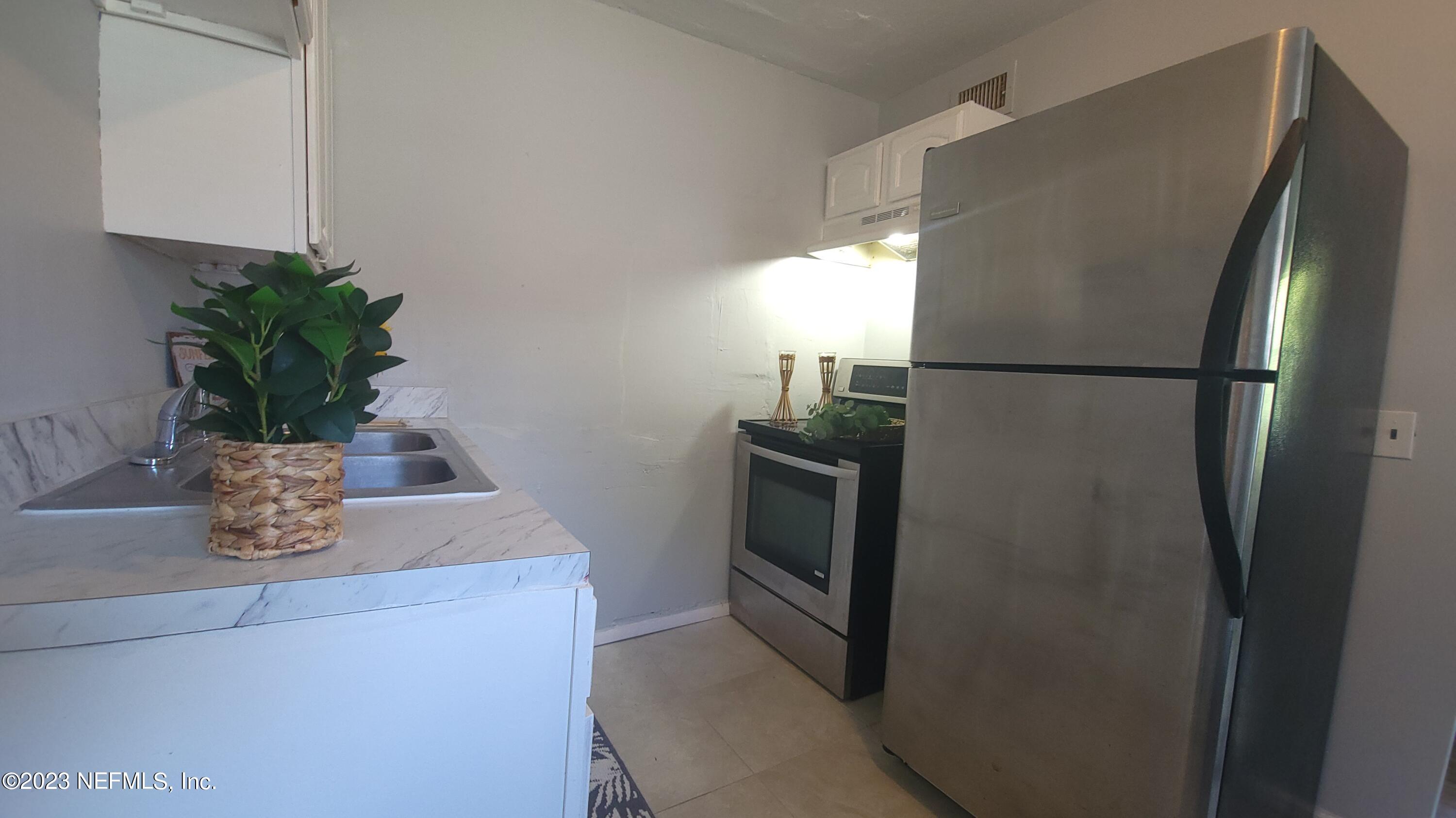 5721 Bree Road Jacksonville, FL 32209 - Photo 6 of 15 a white refrigerator freezer sitting inside of a kitchen