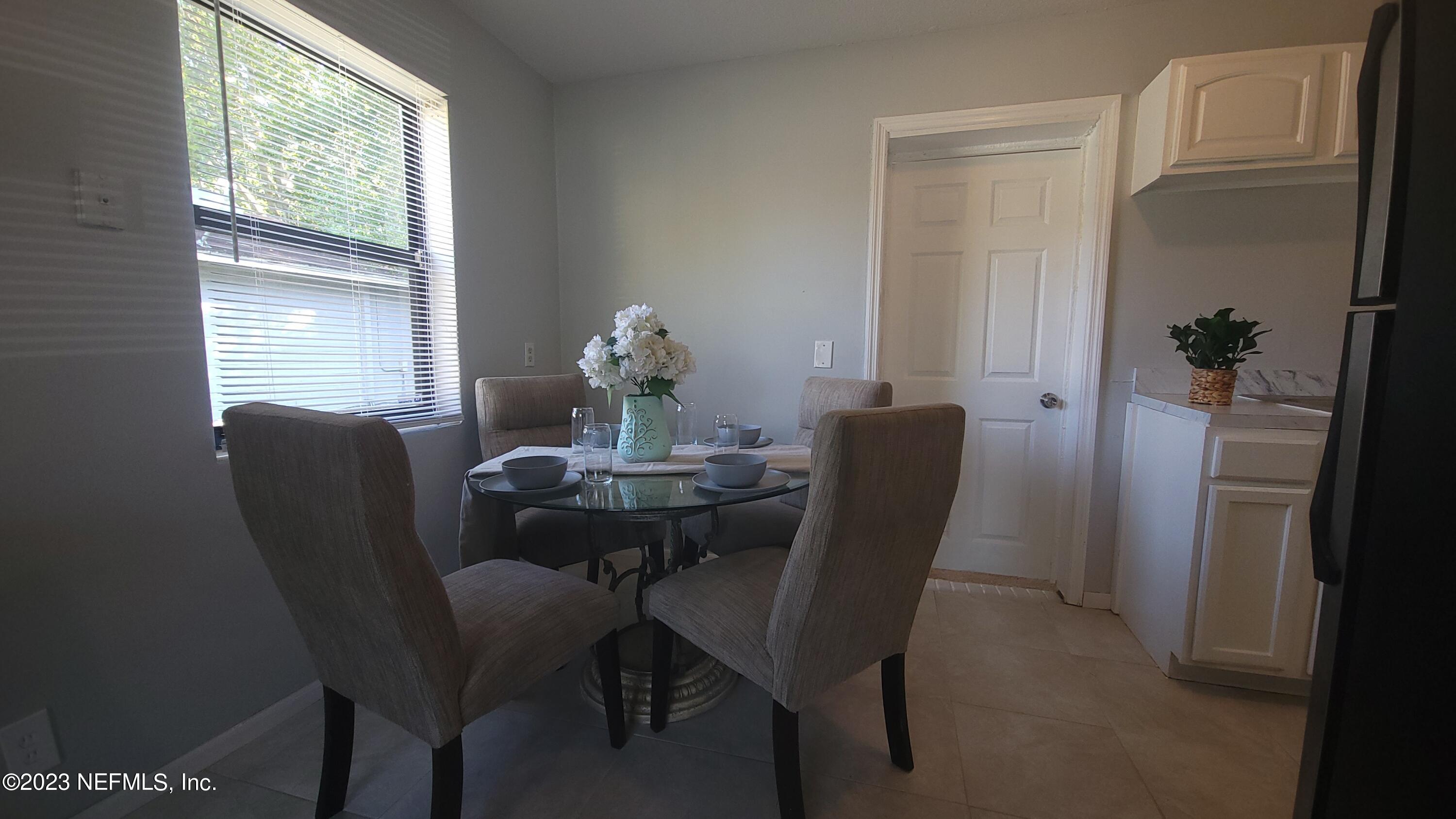 5721 Bree Road Jacksonville, FL 32209 - Photo 7 of 15 a view of a dining room with furniture window and outside view