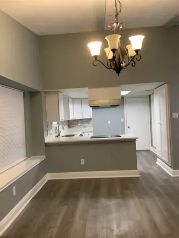 a view of a room with a chandelier and living room view