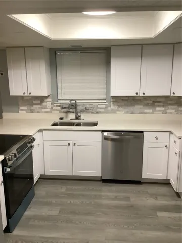a kitchen with a sink stove and cabinets