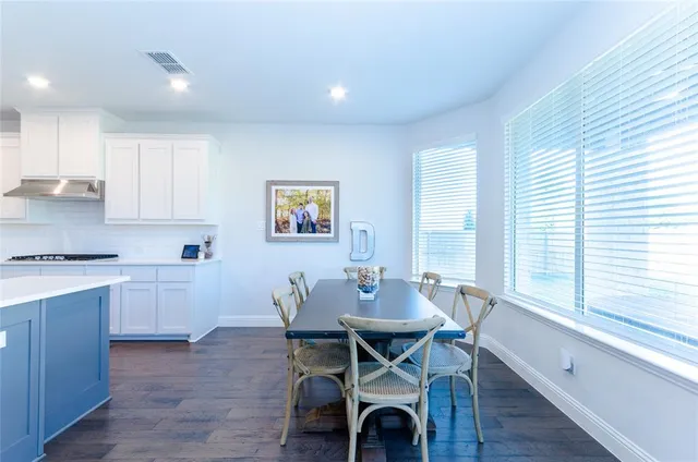 a large kitchen with stainless steel appliances lots of counter space and a sink