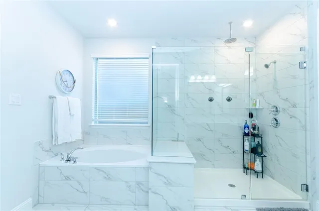 a bathroom with a bathtub and a shower