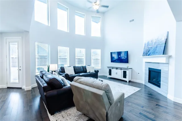 a living room with furniture a fireplace and a wooden floor