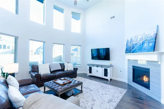 a living room with furniture a flat screen tv and a fireplace