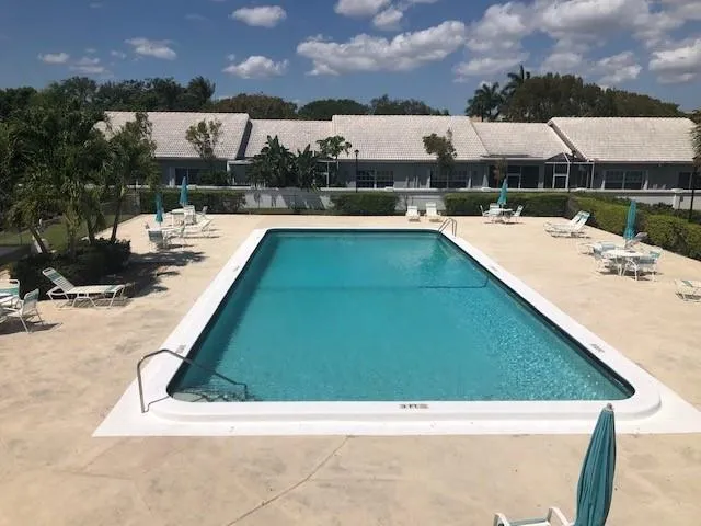 a view of swimming pool with outdoor seating and a lots of buildings in the background