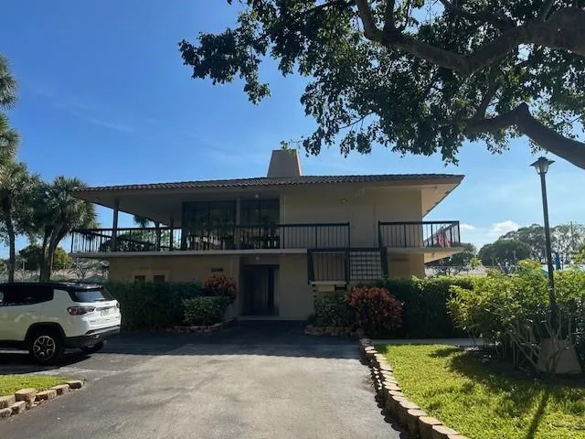 a view of a patio with a table chairs and a fire pit