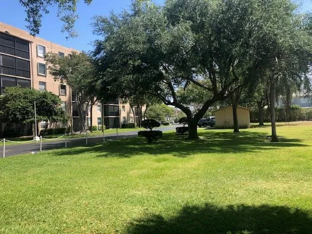 a view of a house with swimming pool and a big yard
