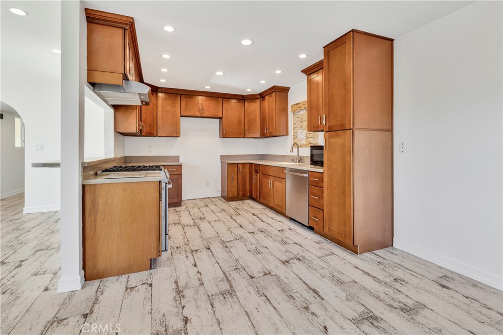 34092 Alcazar Drive, Unit A Dana Point, CA 92629 - Photo 3 of 18 a kitchen with stainless steel appliances granite countertop a refrigerator a stove and a wooden floors