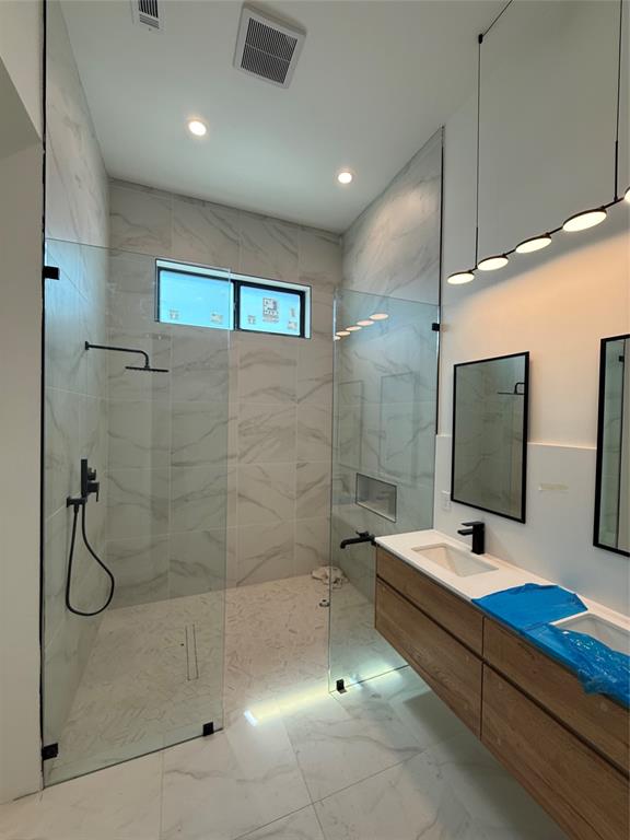 1111 Raiford Road, Unit 105 Carrollton, TX 75007 - Photo 11 of 17 Bathroom with double vanity, a marble finish shower, light marble finish floors, and recessed lighting