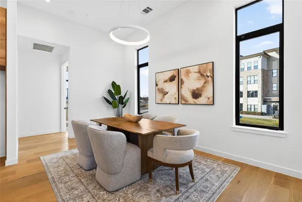 a dining room with furniture and wooden floor