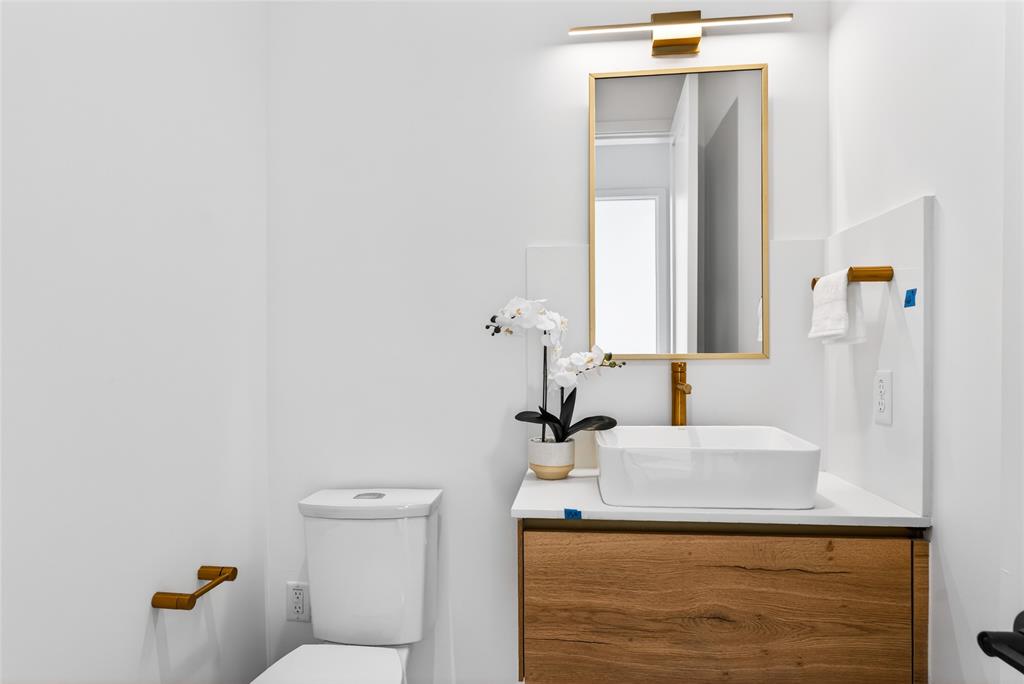 1111 Raiford Road, Unit 105 Carrollton, TX 75007 - Photo 19 of 31 a bathroom with a sink and a toilet