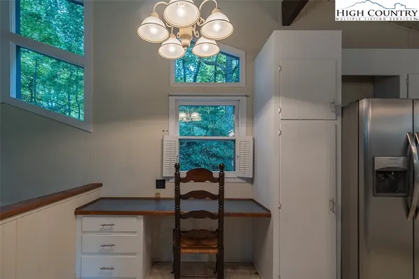 a view of a dining room with a table and chairs